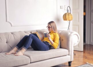 Staying In reading a book on the sofa
